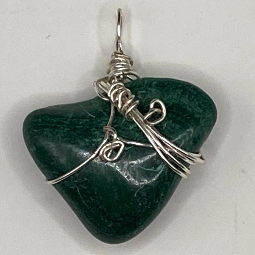 Green stone pendant with silver wire wrapping on a white background