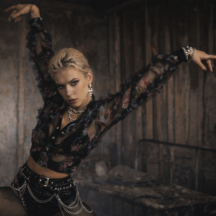 Dancer in a dark, industrial setting with dramatic lighting