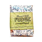 A square seed paper gift wrap featuring a central kraft paper band that reads 'Flower Child FUDGE Caramel Topped'. The top and bottom sections of the wrap are cream-colored with blue botanical illustrations and decorative text.