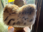 A fluffy, plush faux fur shoulder bag with a tawny, cream, and dark spotted animal print pattern, known as the Tiger Woman purse by La Dee Dah,