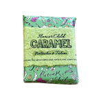 A packaged seed paper product labeled 'Flower Child Caramel Pistachio & Tahiti' with a light green textured center and mint green patterned top and bottom, shown on a plain white background.
