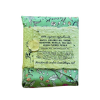 A folded bar of handmade soap in a mint green floral patterned wrapper, tied with a matching lace ribbon and a wooden bead, on a plain white background.