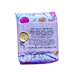 A packaged food product, specifically a folded pouch of coconut flax seed butter, featuring a light purple floral pattern with a gold wax seal on the front label.