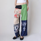 Colorful patchwork pants with various designs and text on a plain background