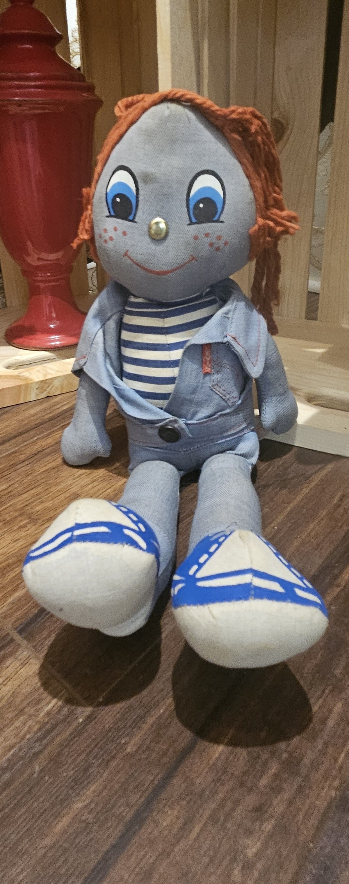 alt="Vintage cloth rag doll crafted in light blue denim with auburn yarn hair, brass button nose, striped shirt, and matching denim vest and pants"