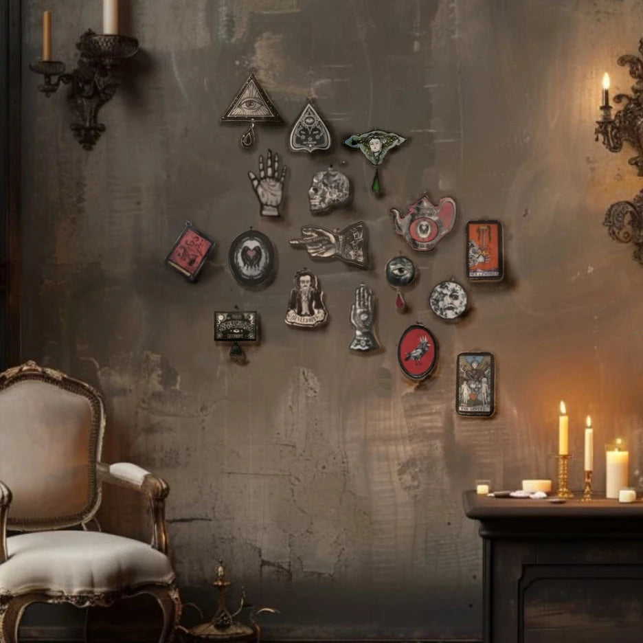 Decorative wall art on a textured wall with candles and a chair in a dimly lit room.