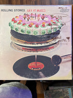 Vintage 1969 original pressing vinyl record jacket for The Rolling Stones Let It Bleed on London Records, featuring the surreal multi-tier cake sculpture artwork.