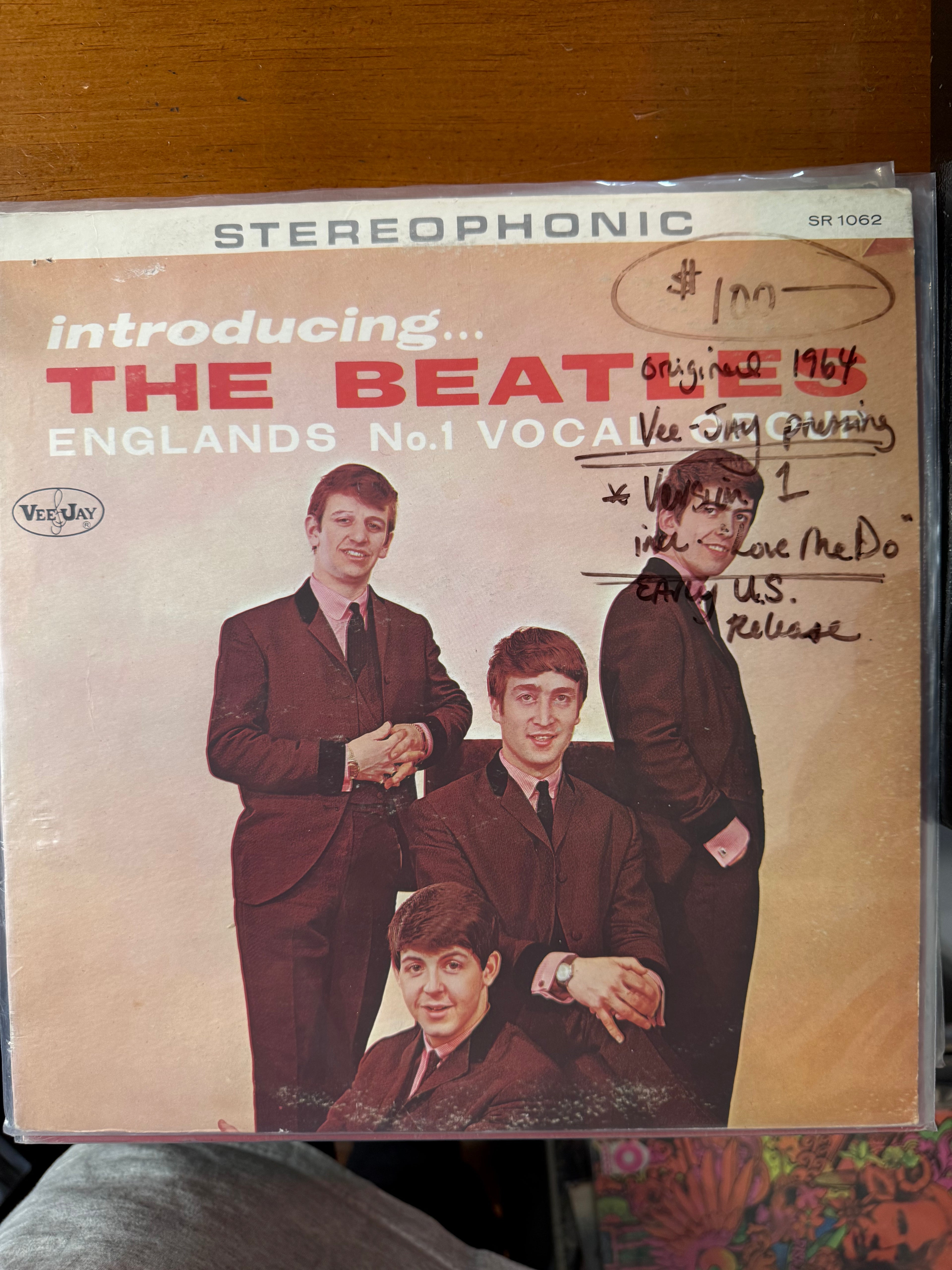 Front jacket cover of Introducing... The Beatles on Vee-Jay Records featuring a vintage full-length photograph of John Lennon, Paul McCartney, George Harrison, and Ringo Starr in dark suits against a cream background.