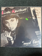 Vintage vinyl record cover for Linda Ronstadt's 1980 album Mad Love, featuring a high-contrast black-and-white portrait of Linda Ronstadt holding a telephone receiver with stylized pink and white typography.