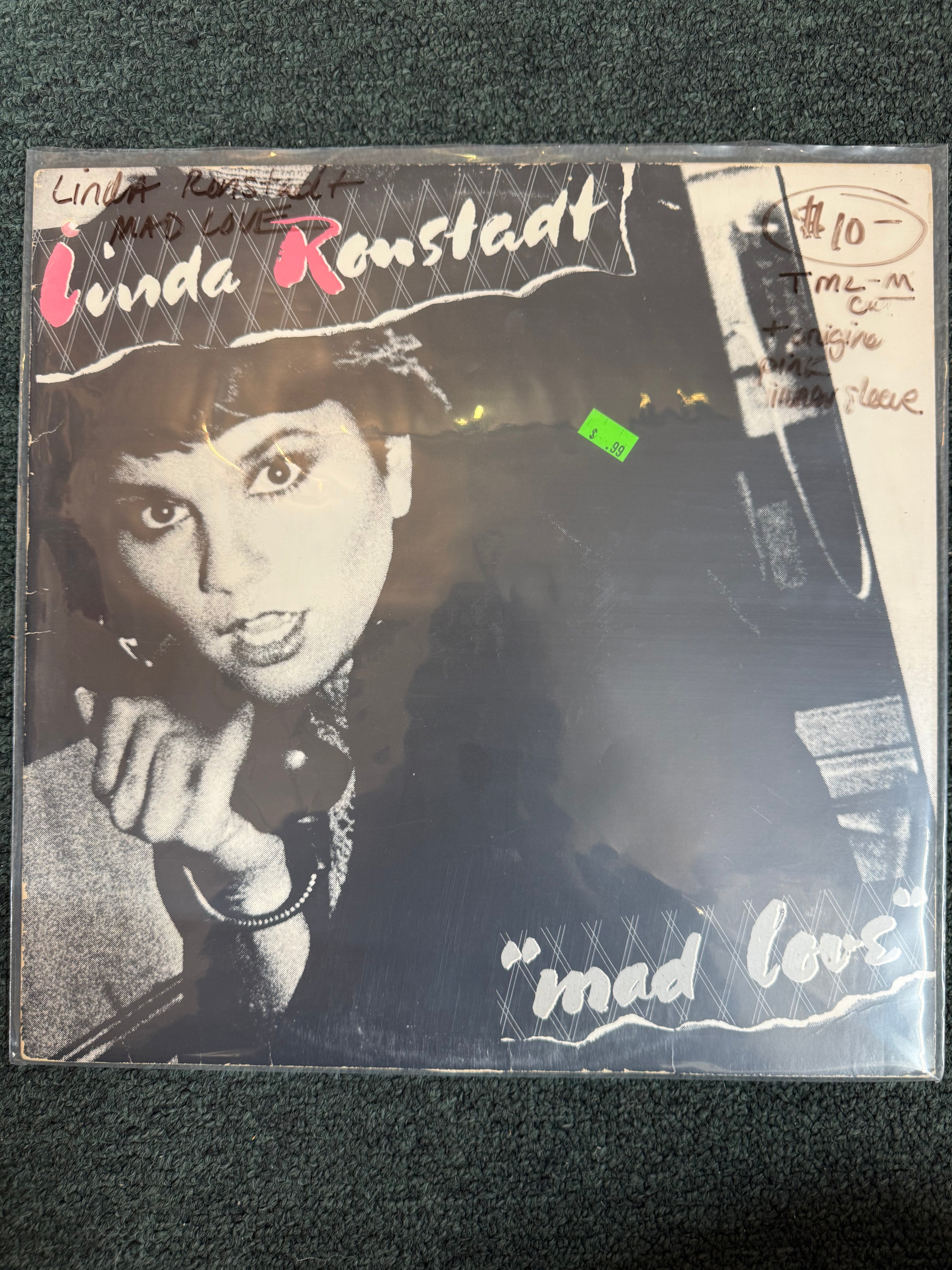 Vintage vinyl record cover for Linda Ronstadt's 1980 album Mad Love, featuring a high-contrast black-and-white portrait of Linda Ronstadt holding a telephone receiver with stylized pink and white typography.