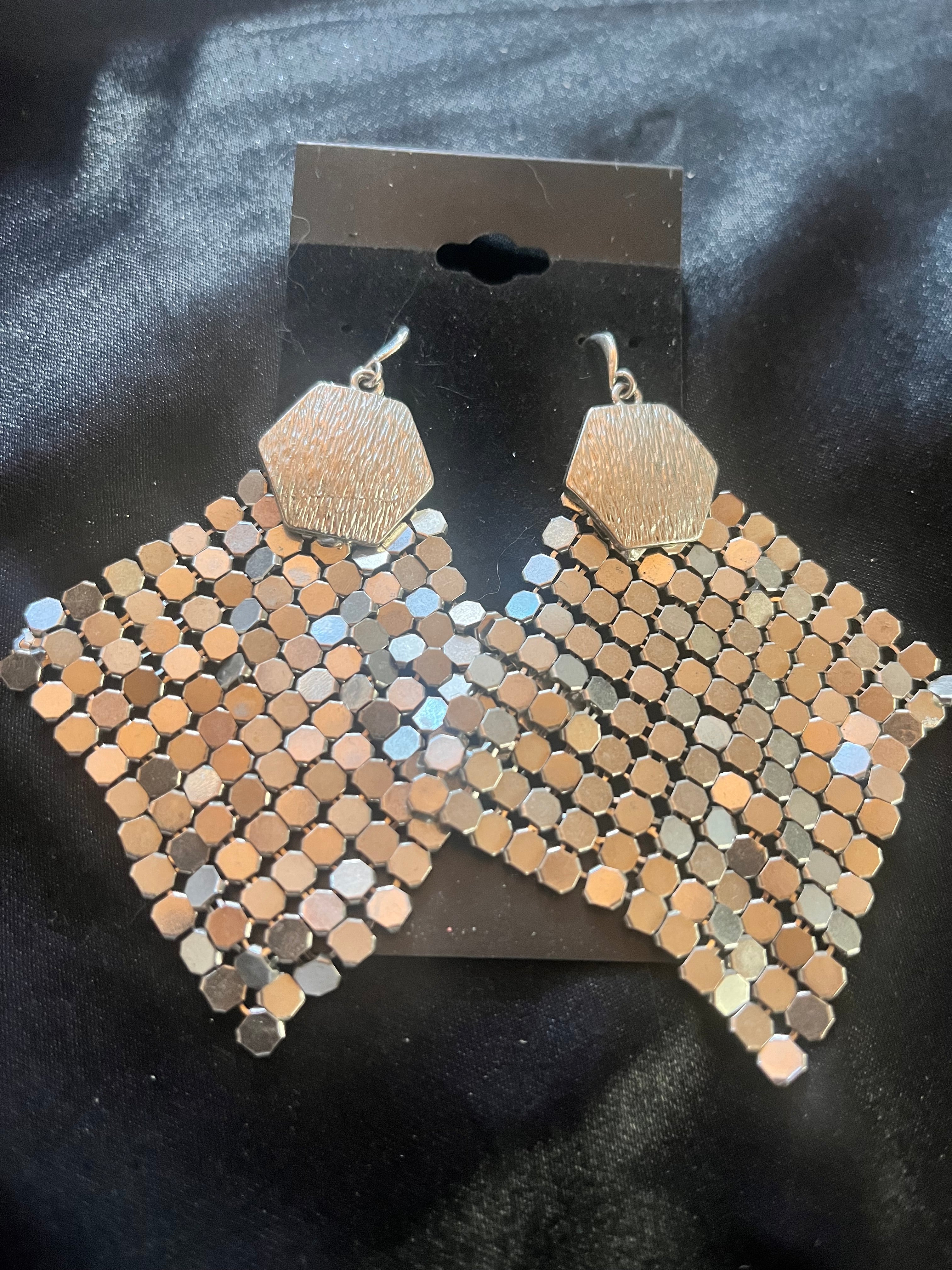 Shop our vintage silver chain maille statement earrings. These retro liquid metallic mesh dangles feature textured hexagonal tops and fluid diamond-shaped drops.